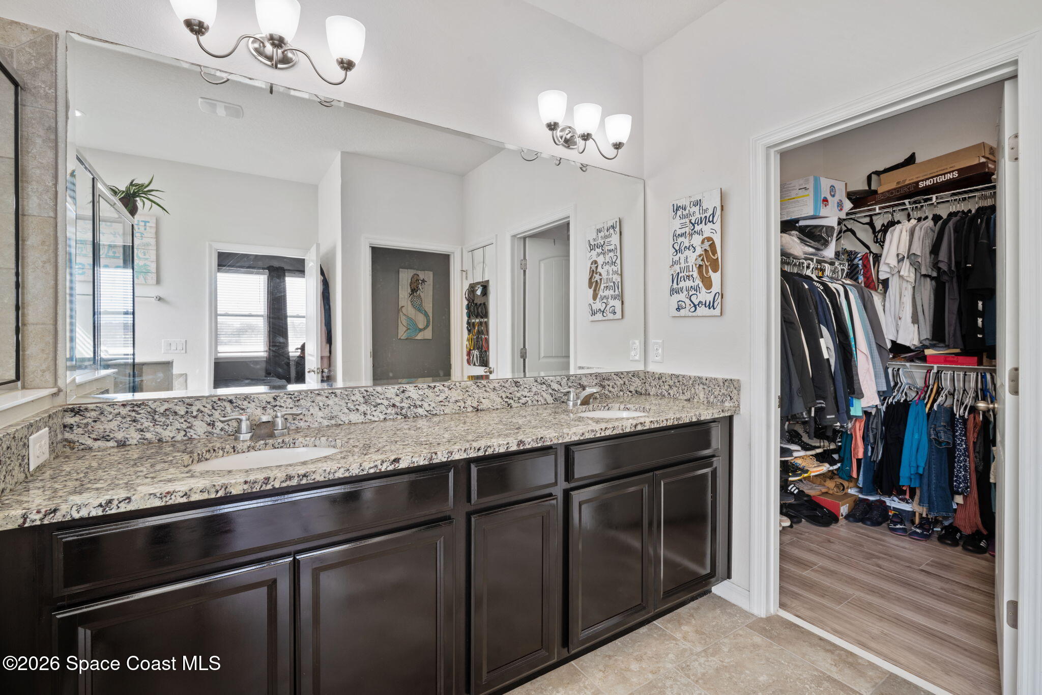 1941 Partin Terrace Road Kissimmee, FL 34744 - Photo 11 of 36 a bathroom with a granite countertop sink a large mirror and a window