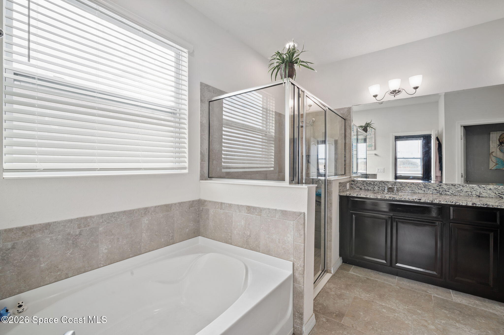 1941 Partin Terrace Road Kissimmee, FL 34744 - Photo 12 of 36 a bathroom with a granite countertop sink and a bathtub
