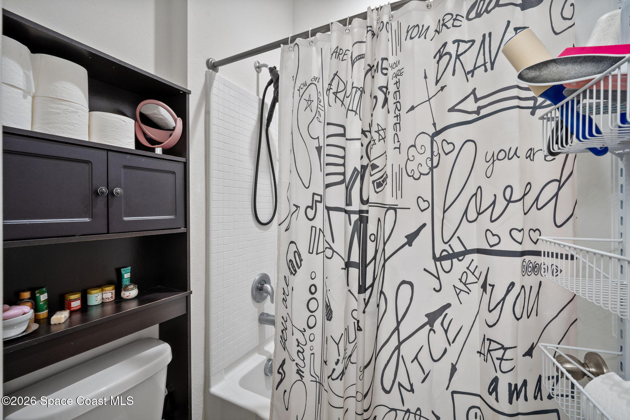 1941 Partin Terrace Road Kissimmee, FL 34744 - Photo 15 of 36 a bathroom with a bathtub and shower curtain