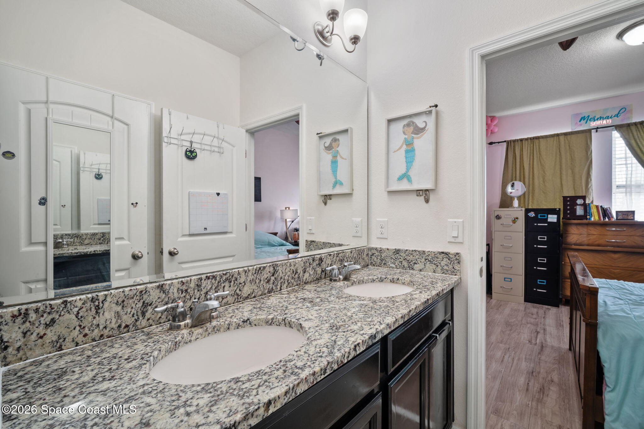 1941 Partin Terrace Road Kissimmee, FL 34744 - Photo 16 of 36 a bathroom with a granite countertop sink a mirror and a shower