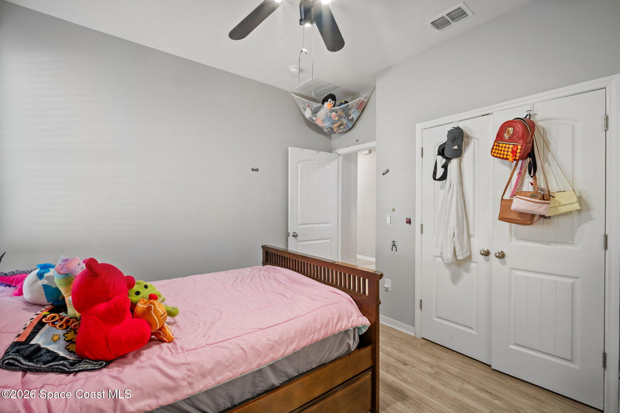 1941 Partin Terrace Road Kissimmee, FL 34744 - Photo 19 of 36 a bedroom with a bed and a chandelier