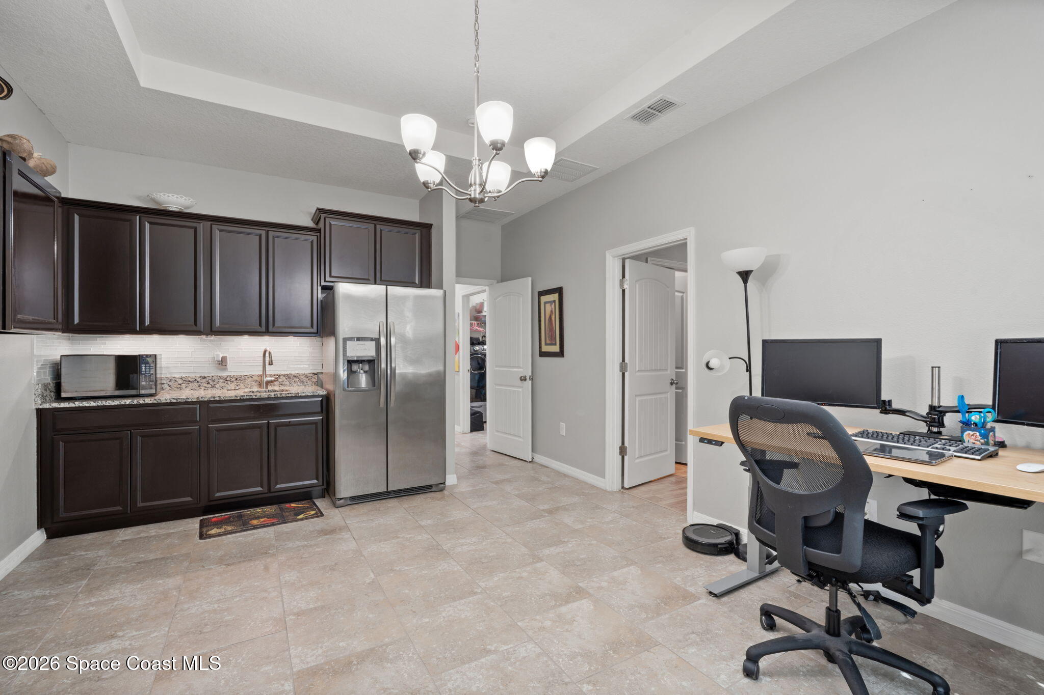 1941 Partin Terrace Road Kissimmee, FL 34744 - Photo 27 of 36 a view of a kitchen with refrigerator and cabinets