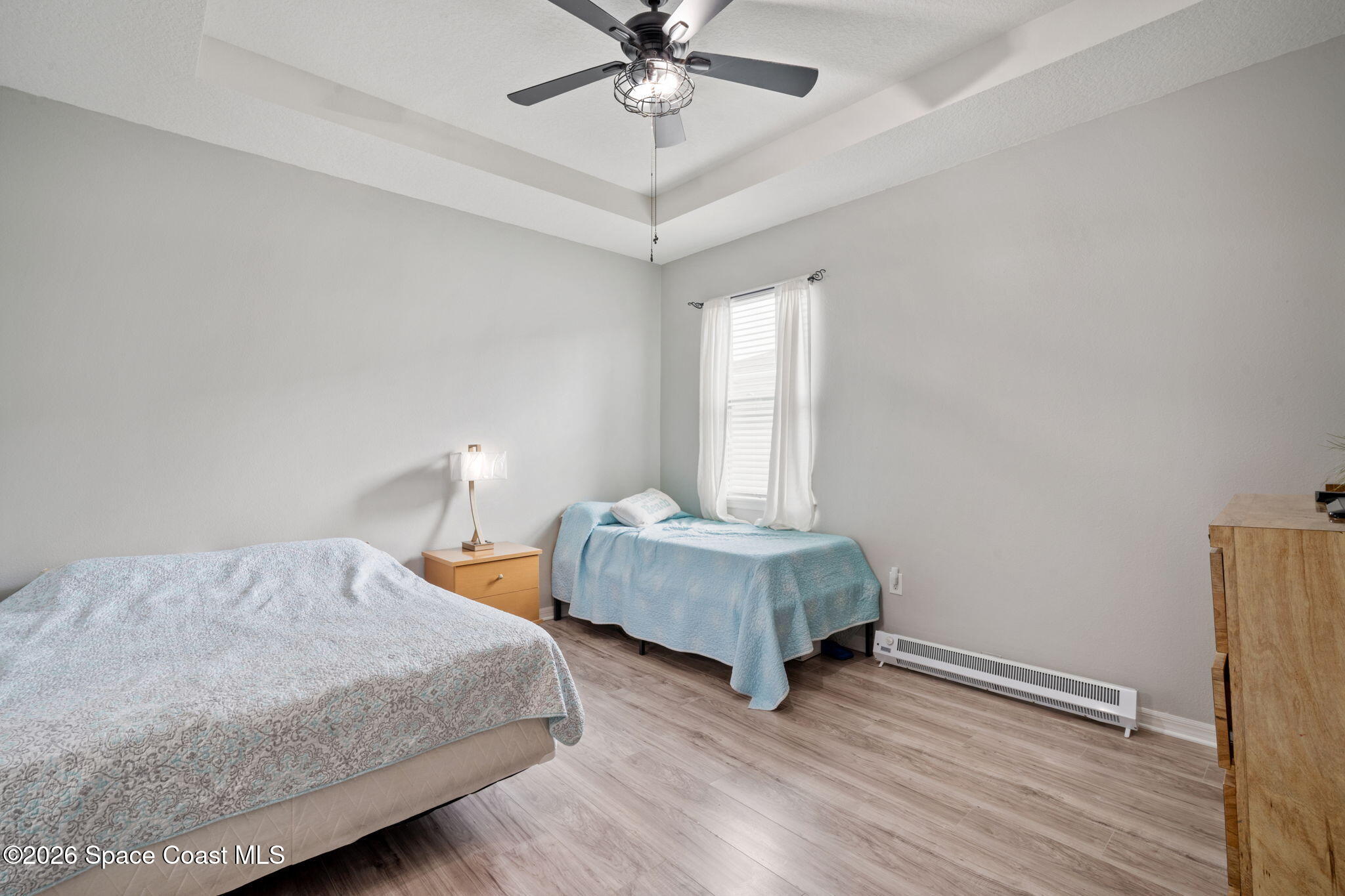 1941 Partin Terrace Road Kissimmee, FL 34744 - Photo 28 of 36 a bedroom with two beds and a chandelier
