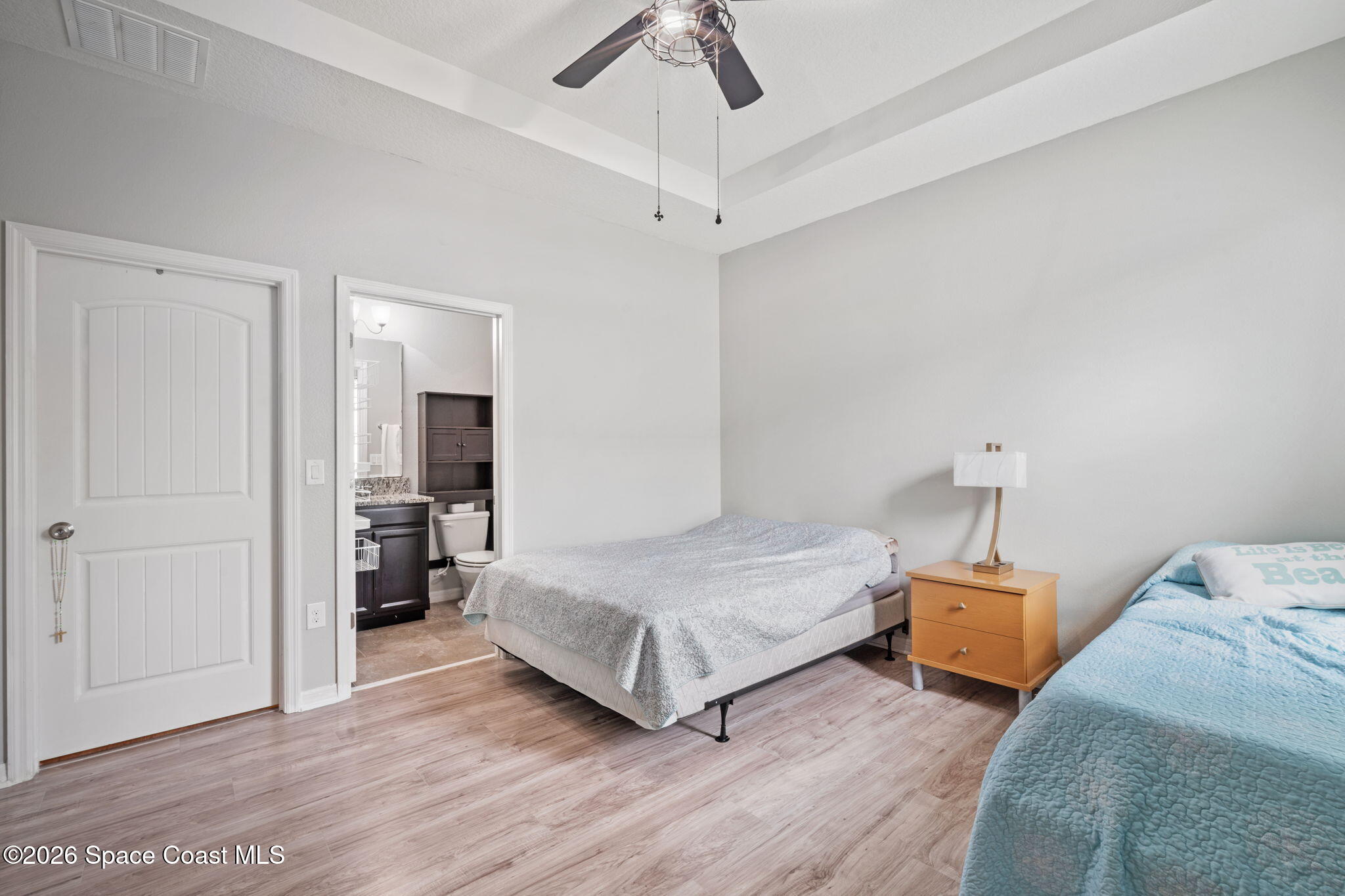 1941 Partin Terrace Road Kissimmee, FL 34744 - Photo 29 of 36 a bedroom with a bed and a chandelier