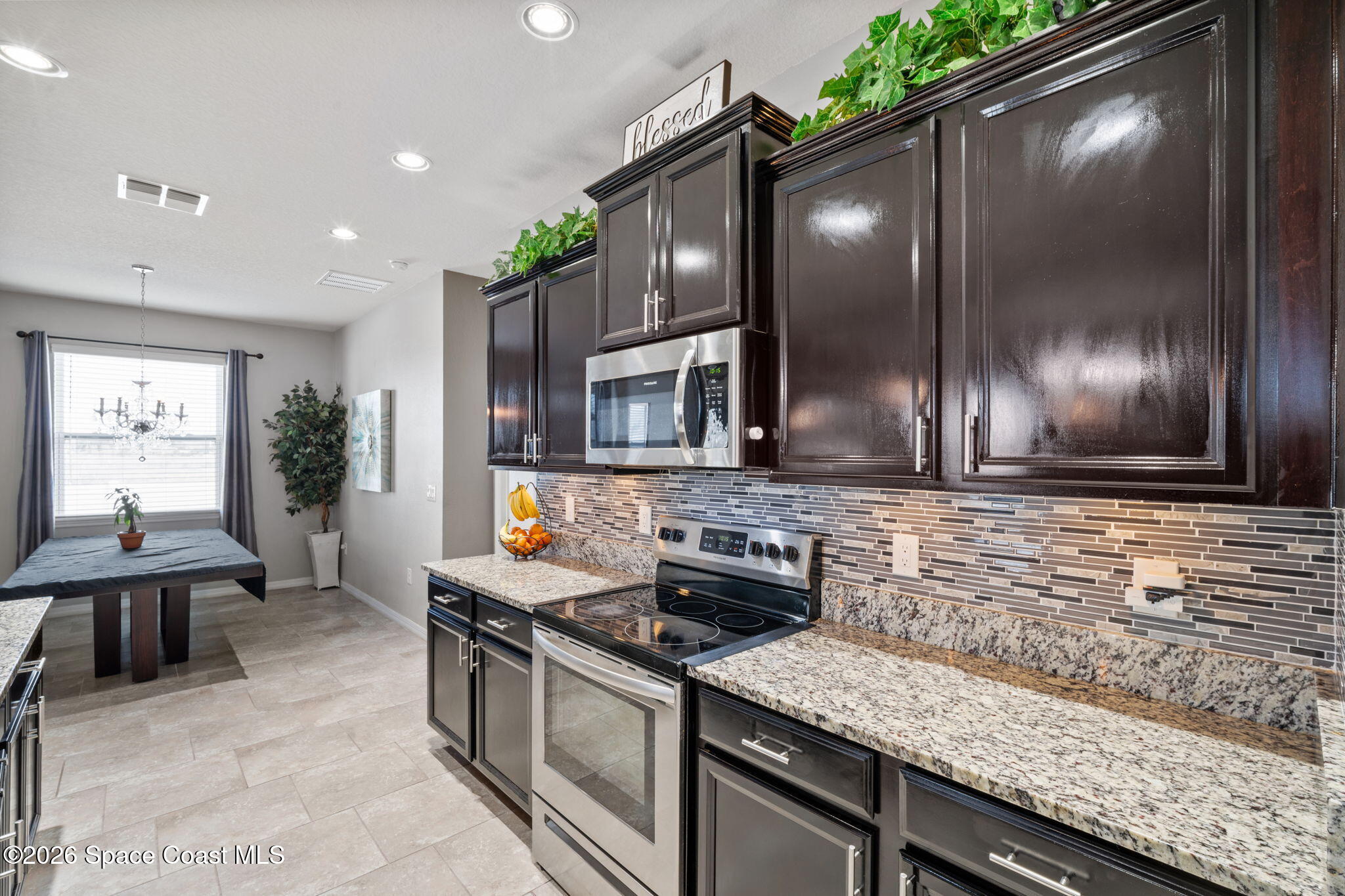 1941 Partin Terrace Road Kissimmee, FL 34744 - Photo 5 of 36 a kitchen with stainless steel appliances granite countertop a sink stove and cabinets