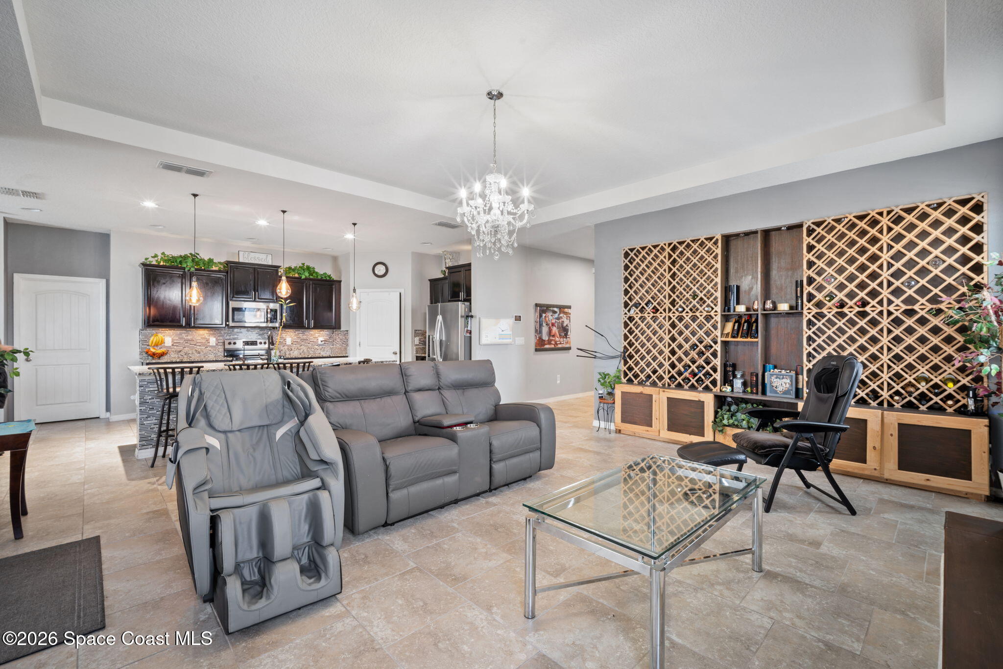 1941 Partin Terrace Road Kissimmee, FL 34744 - Photo 7 of 36 a living room with furniture and a chandelier