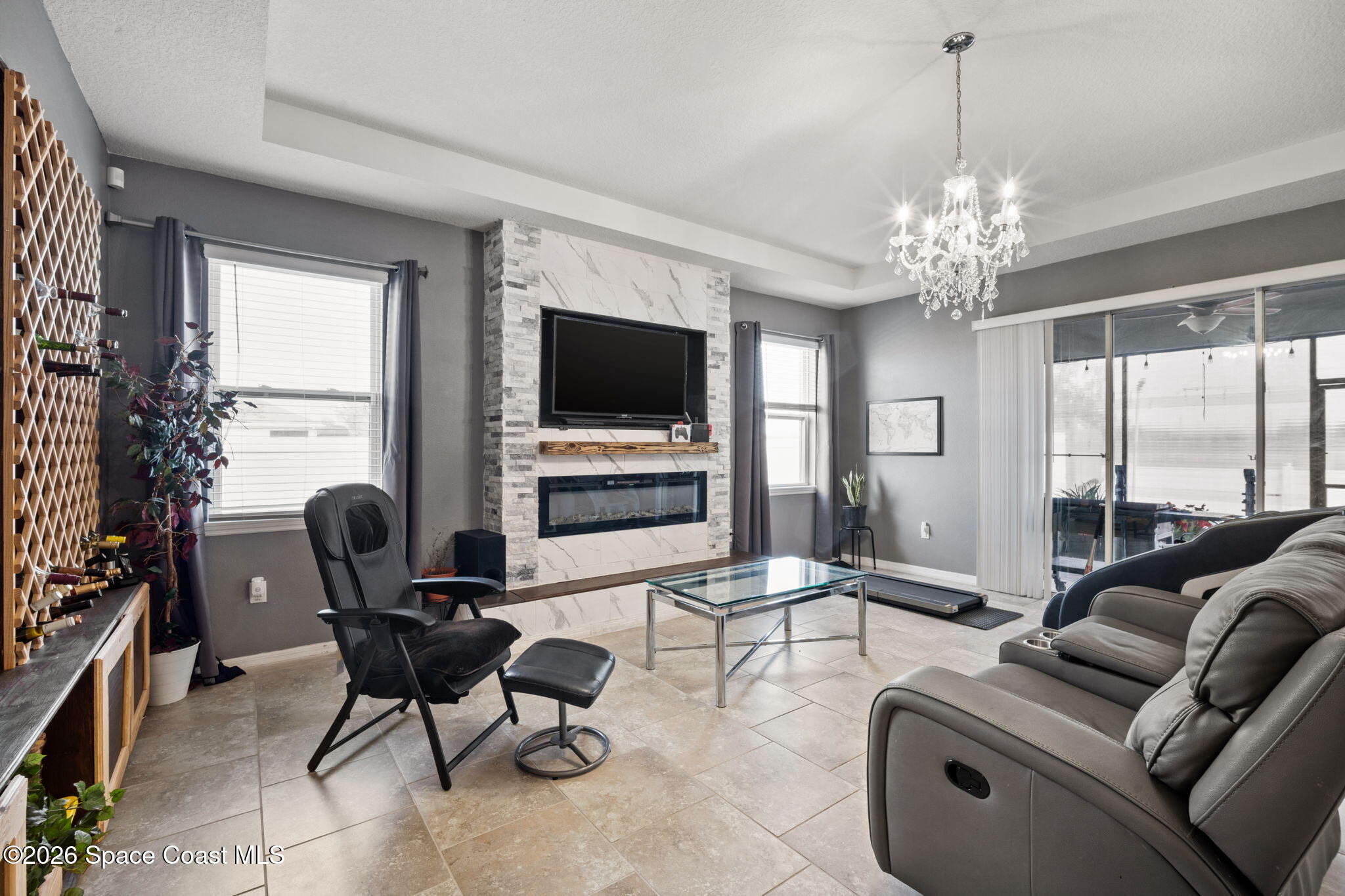 1941 Partin Terrace Road Kissimmee, FL 34744 - Photo 8 of 36 a living room with furniture a flat screen tv and a large window