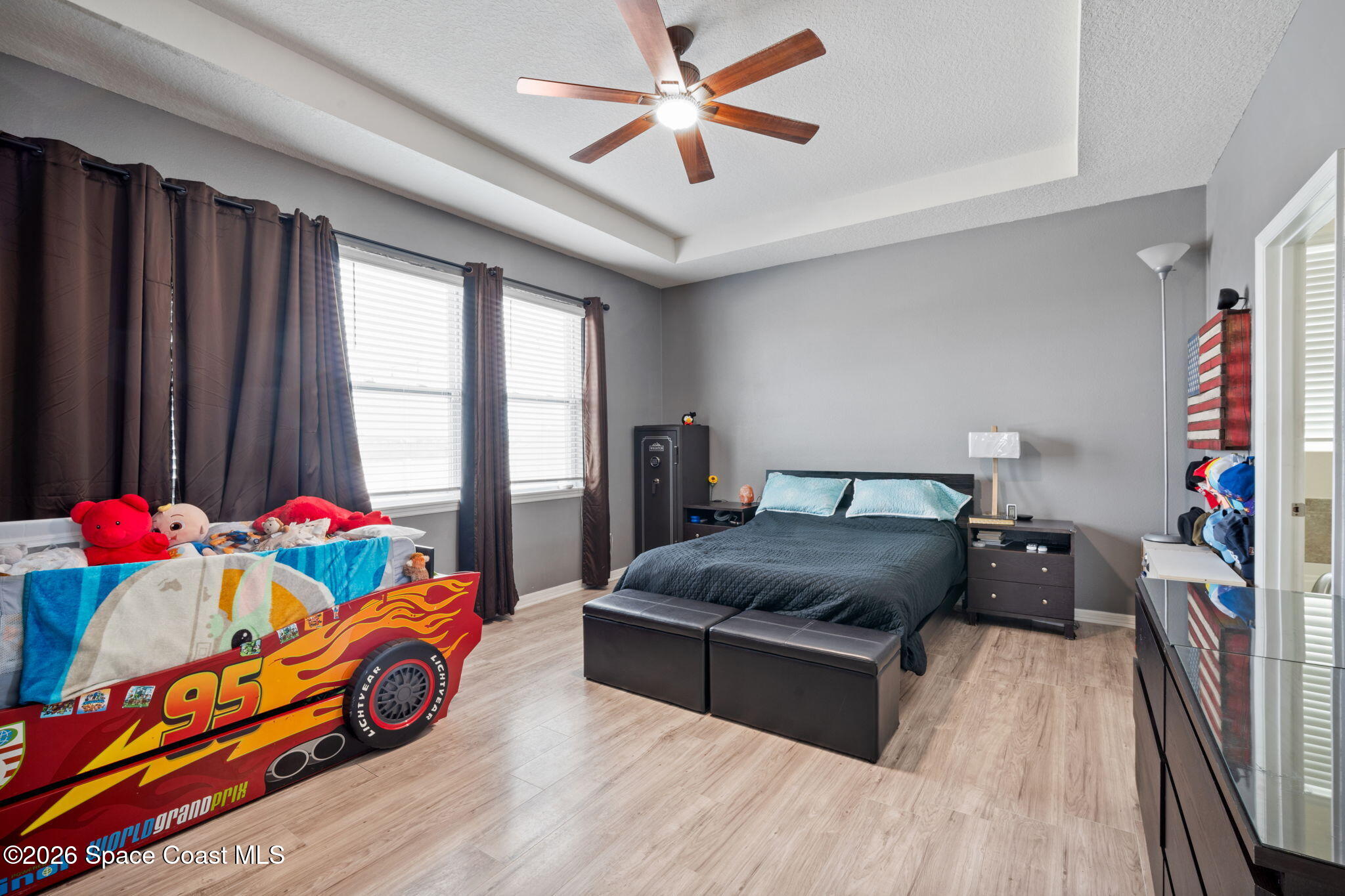 1941 Partin Terrace Road Kissimmee, FL 34744 - Photo 9 of 36 a bedroom with a bed and a chandelier