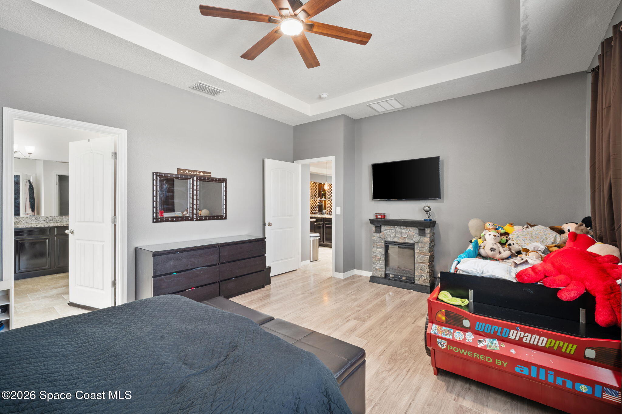 1941 Partin Terrace Road Kissimmee, FL 34744 - Photo 10 of 36 a bedroom with furniture and a flat screen tv