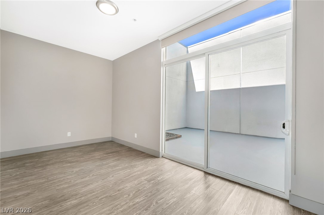 2775 West Pebble Road, Unit 505 Las Vegas, NV 89123 - Photo 20 of 26 Sliding glass doors open to an inviting outdoor space, expanding the living area.