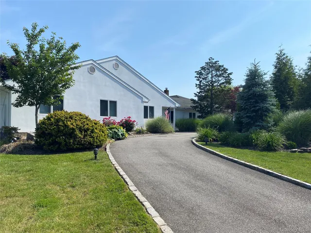 a front view of house with yard and green space