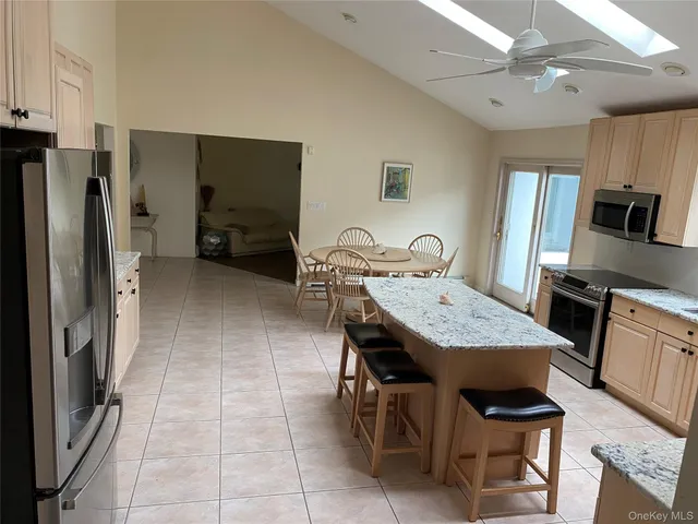 a view of kitchen with sink refrigerator and microwave
