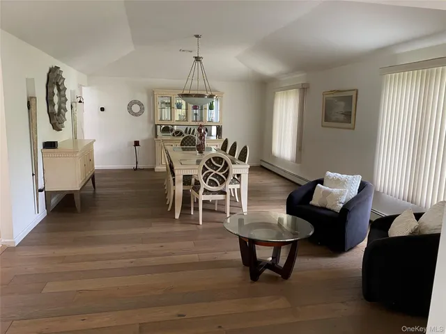 a living room with furniture a window and a chandelier