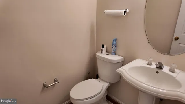 a white toilet sitting next to a bathroom sink