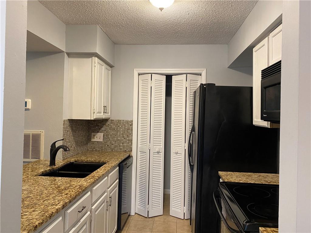 11111 Harrowfield Road Charlotte, NC 28226 - Photo 5 of 26 a kitchen with granite countertop a refrigerator stove and sink