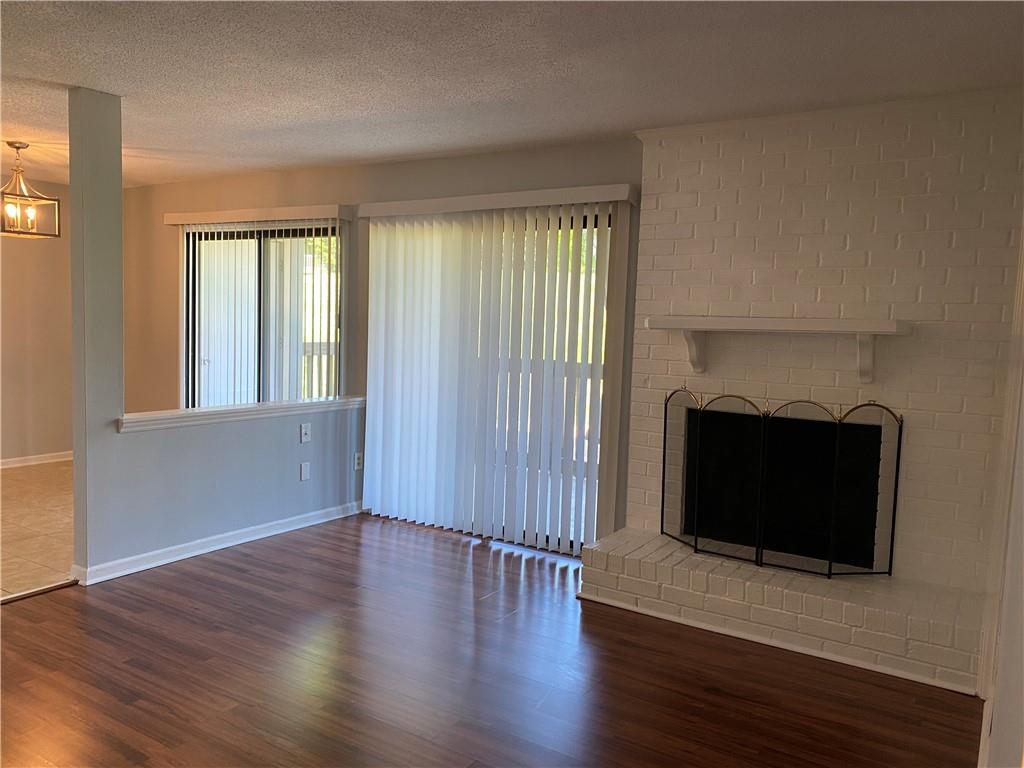 11111 Harrowfield Road Charlotte, NC 28226 - Photo 8 of 26 a view of a room with wooden floor and fireplace