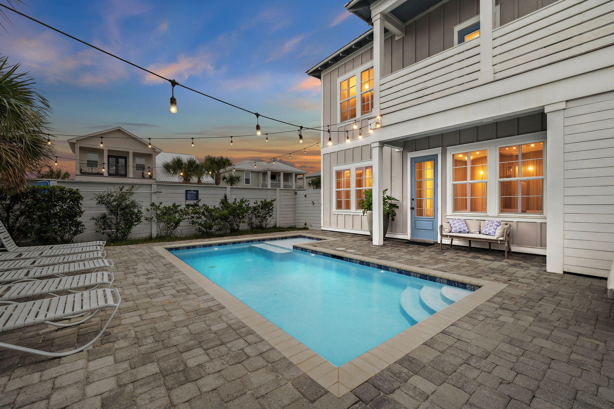 a view of a patio with swimming pool table and chairs