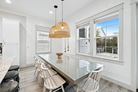 a kitchen with kitchen island a dining table and chairs