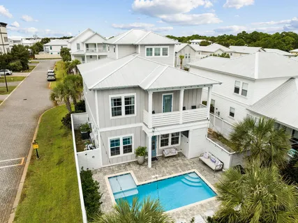 a view of a house with pool and sitting area