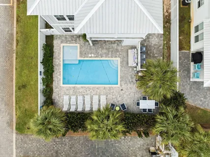 a view of a patio with swimming pool table and chairs