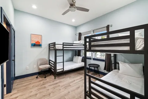 a bedroom with bed and wooden floor