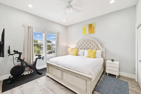 a large bedroom with a bed and wooden floor