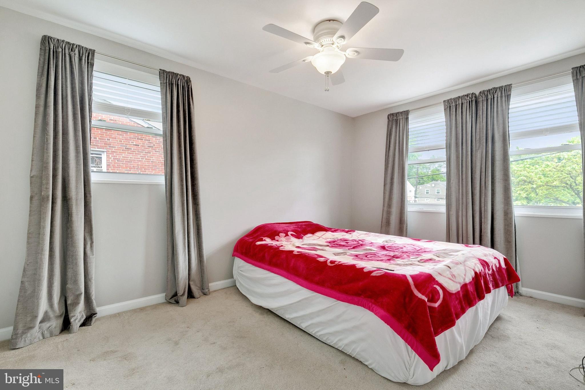 12114 Dalewood Drive Silver Spring, MD 20902 - Photo 11 of 24 a bedroom with a bed and a window