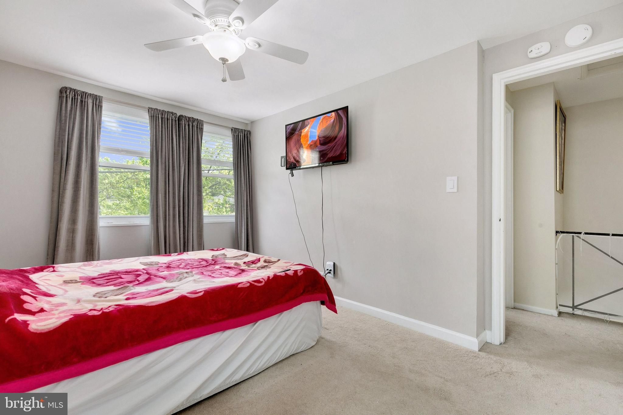 12114 Dalewood Drive Silver Spring, MD 20902 - Photo 12 of 24 a bedroom with a bed and a flat screen tv