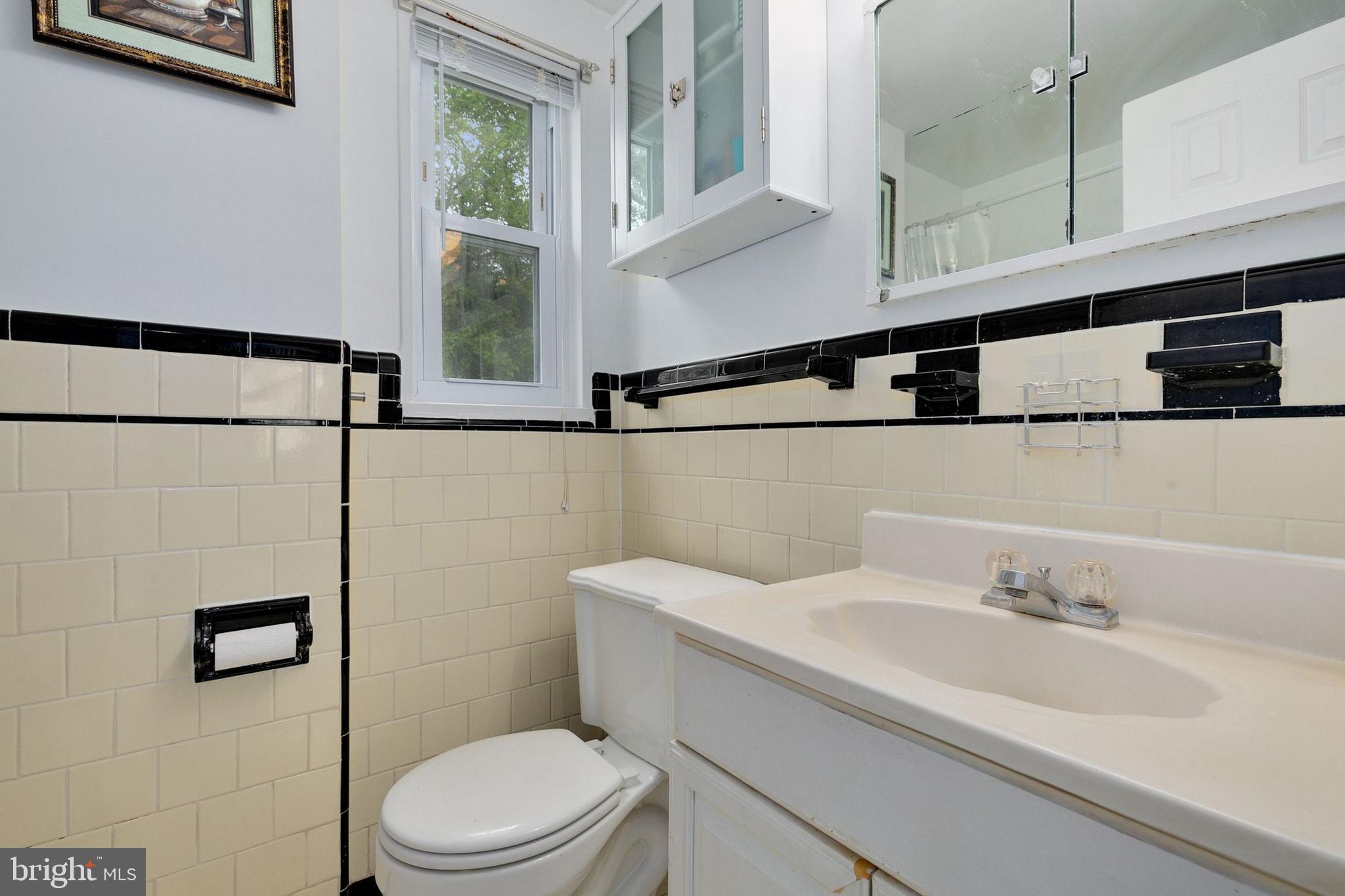12114 Dalewood Drive Silver Spring, MD 20902 - Photo 13 of 24 a bathroom with a sink a toilet and shower