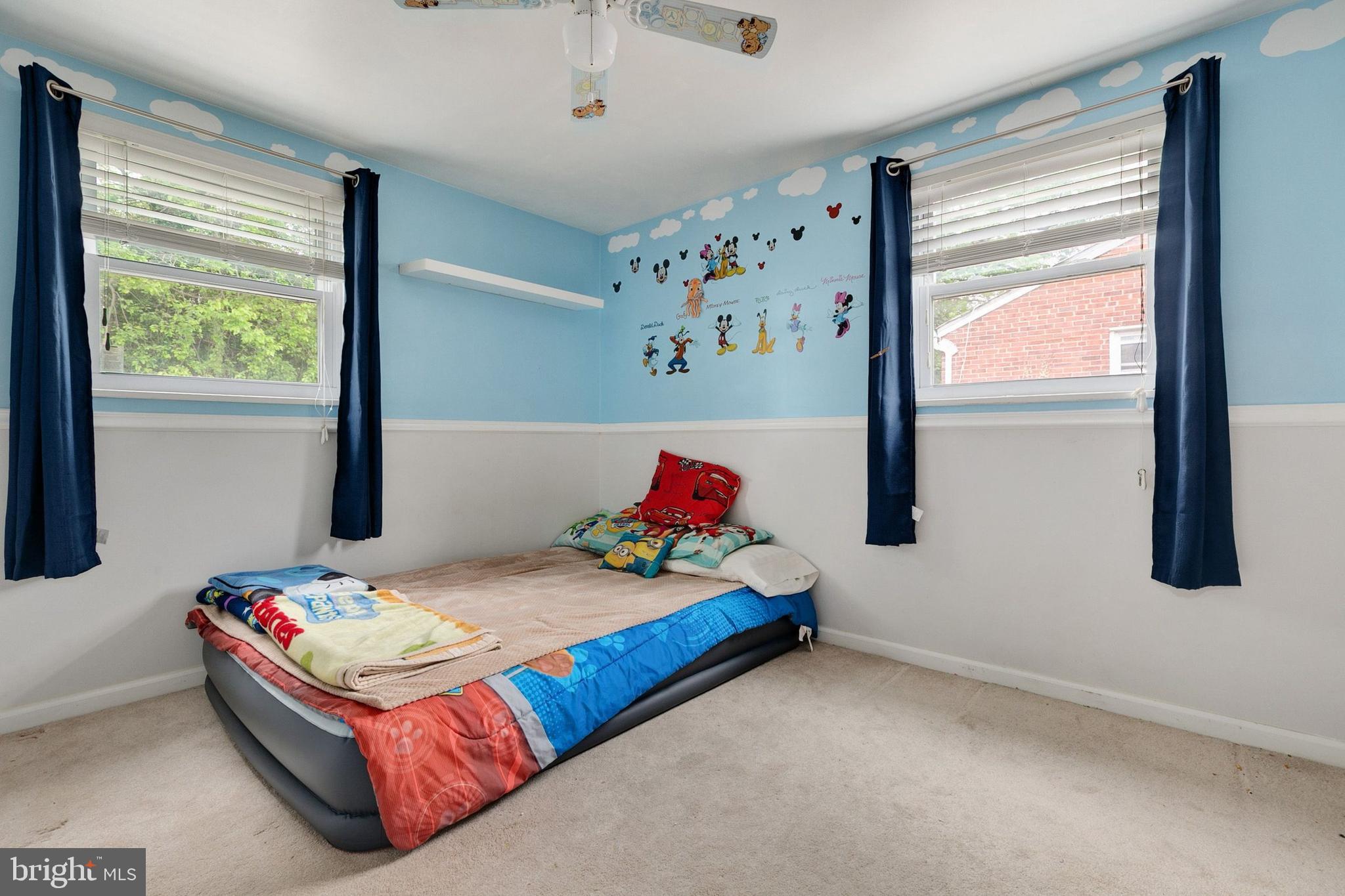 12114 Dalewood Drive Silver Spring, MD 20902 - Photo 16 of 24 a bedroom with a bed and window