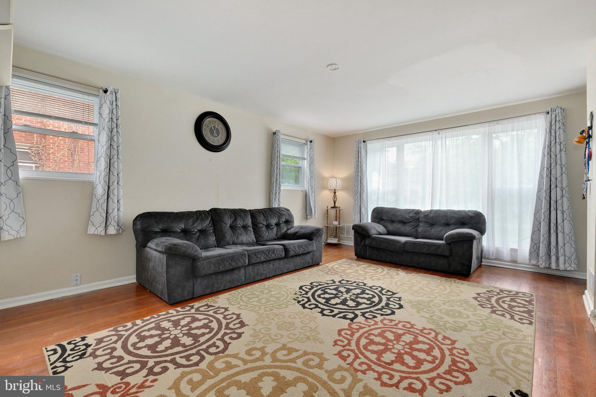 12114 Dalewood Drive Silver Spring, MD 20902 - Photo 5 of 24 a living room with a couch and a dresser with wooden floor