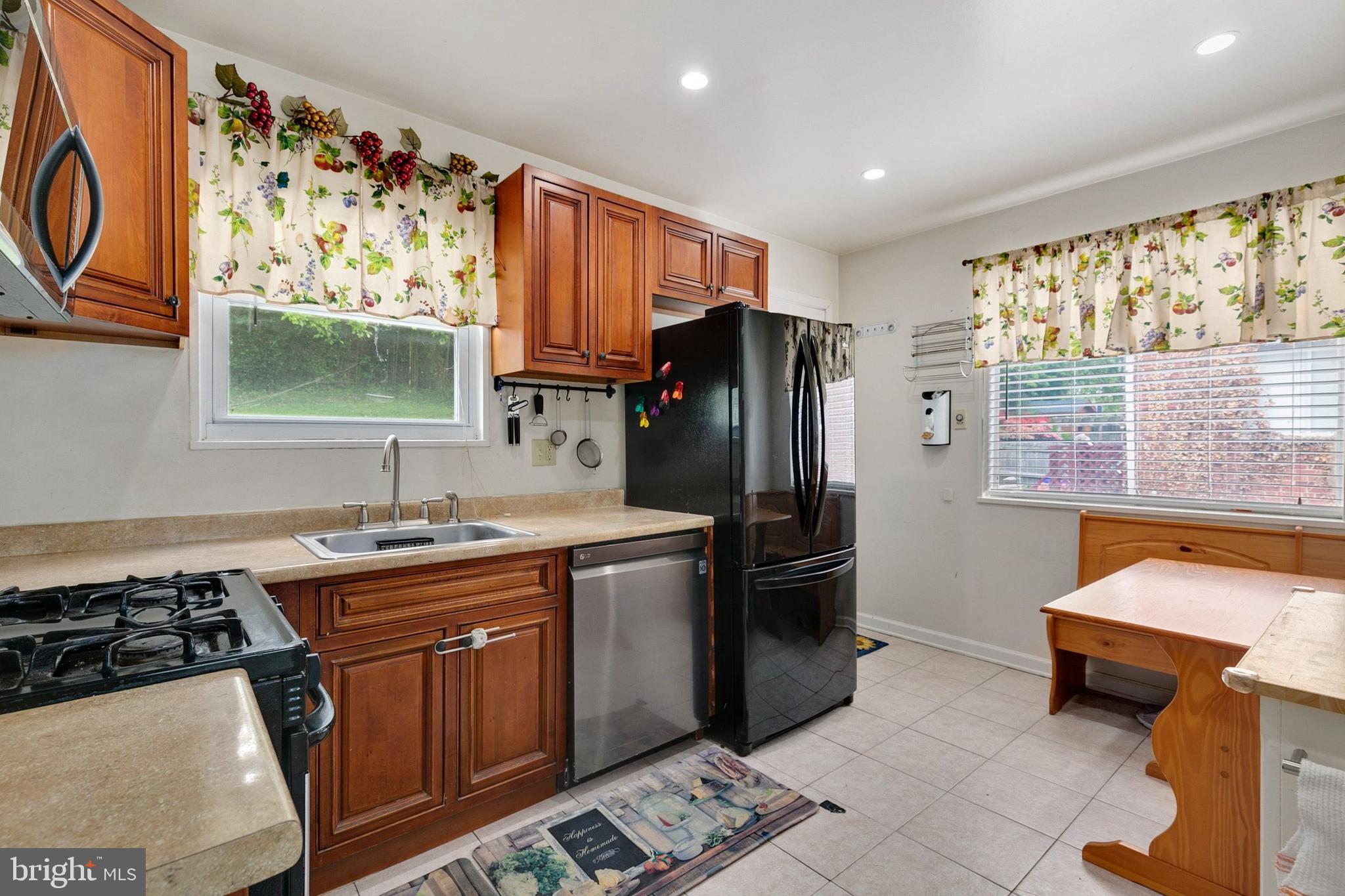 12114 Dalewood Drive Silver Spring, MD 20902 - Photo 8 of 24 a kitchen with stainless steel appliances granite countertop a refrigerator and a stove