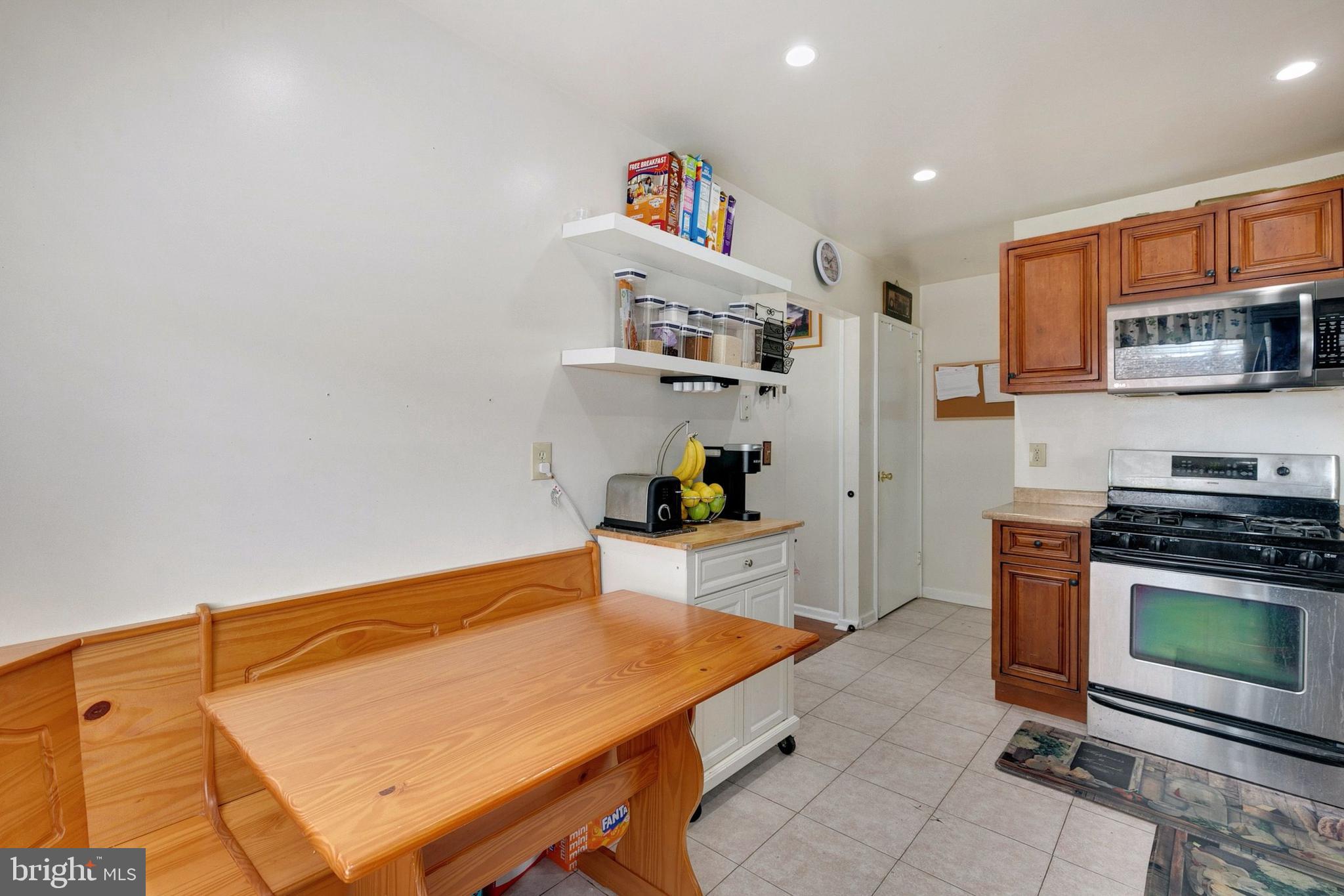 12114 Dalewood Drive Silver Spring, MD 20902 - Photo 9 of 24 a kitchen with stainless steel appliances a stove a sink and a refrigerator