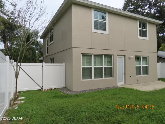 a view of house with backyard