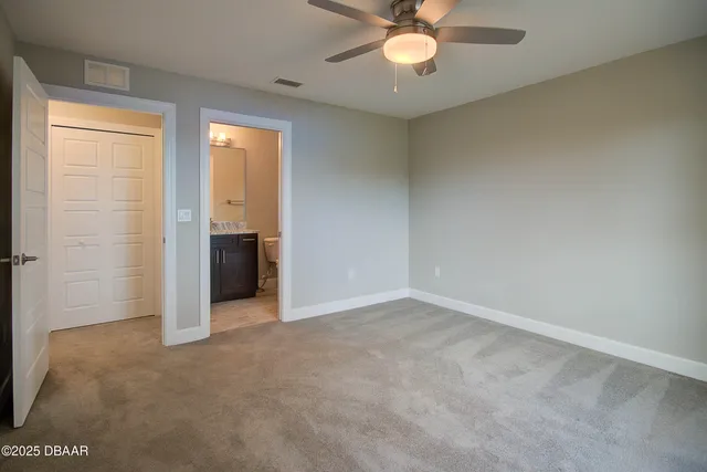 an empty room with chandelier fan