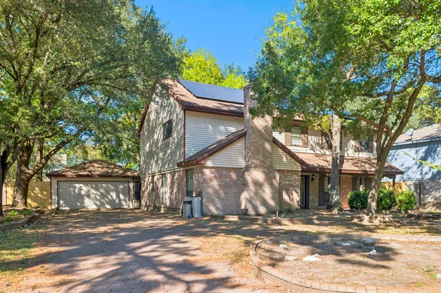 a view of a house with a yard and tree s