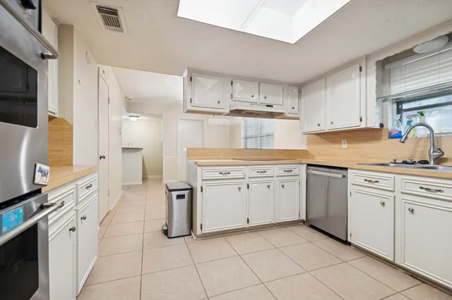 a kitchen with cabinets and appliances
