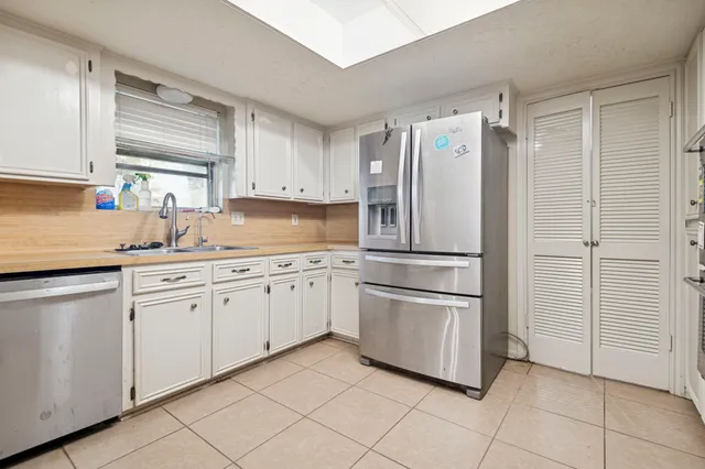 a kitchen with appliances cabinets and a sink