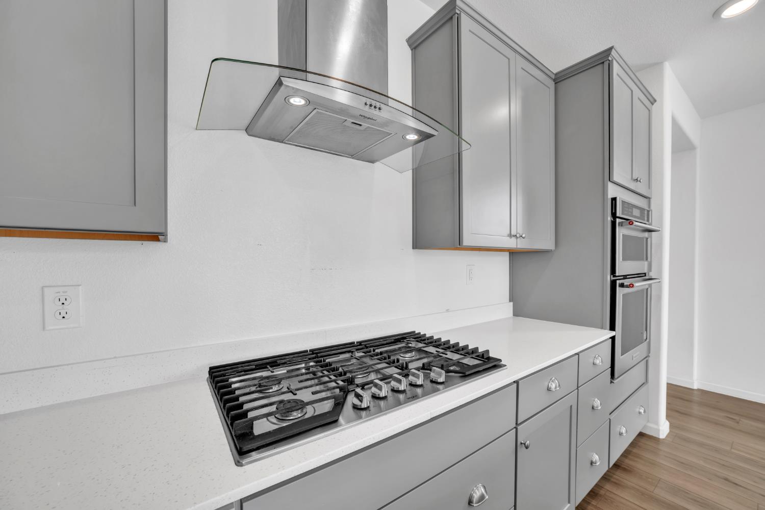 4562 Butterfly Ridge Drive Folsom, CA 95630 - Photo 11 of 44 a kitchen with white cabinets and white appliances