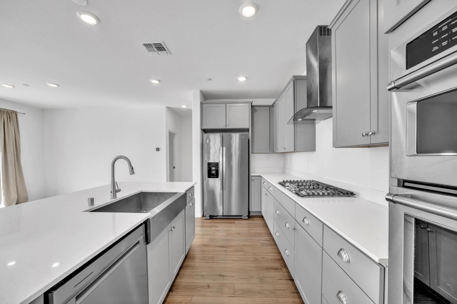 4562 Butterfly Ridge Drive Folsom, CA 95630 - Photo 12 of 44 a kitchen with stainless steel appliances granite countertop a sink stove and refrigerator