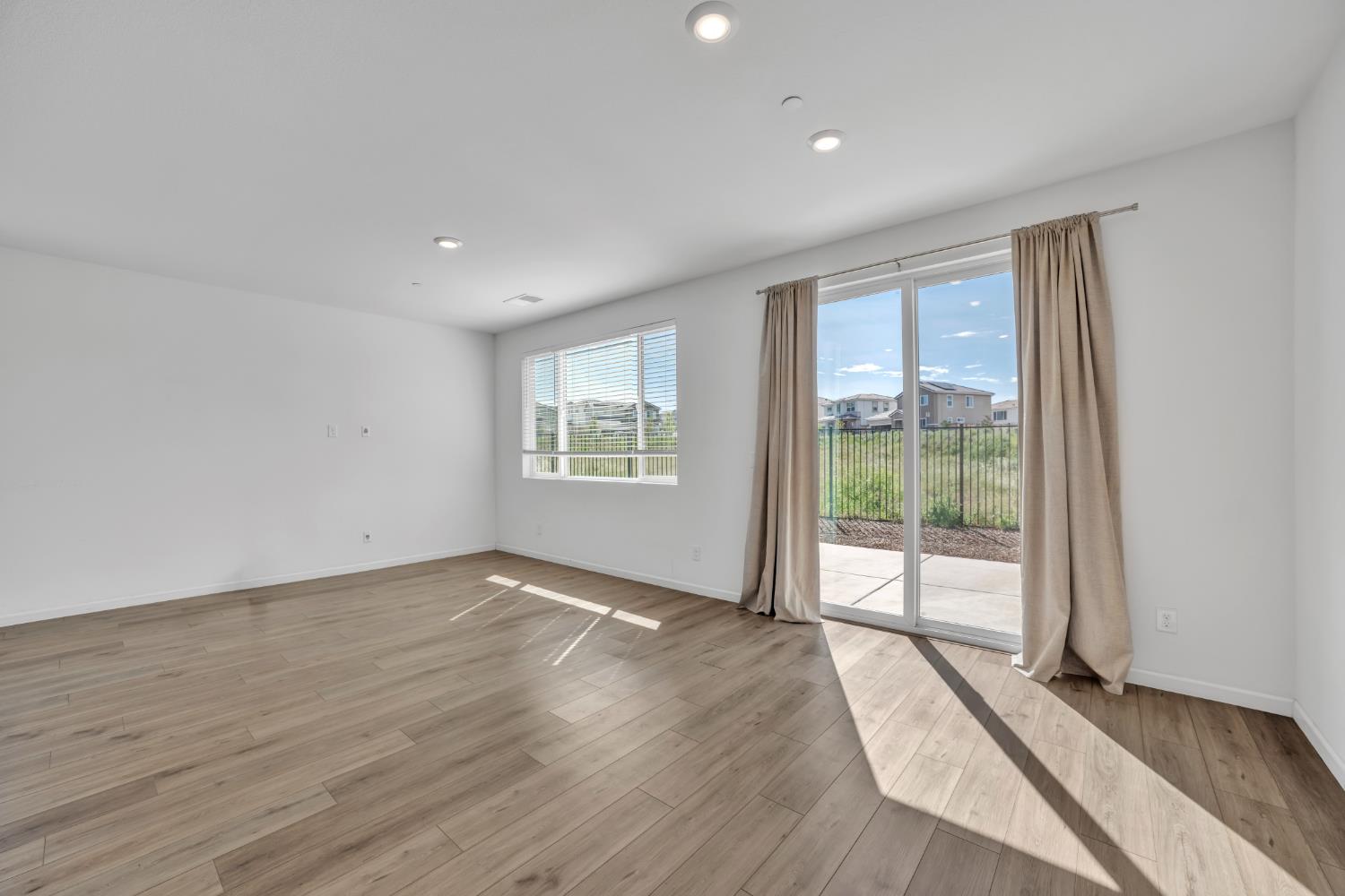 4562 Butterfly Ridge Drive Folsom, CA 95630 - Photo 13 of 44 a view of an empty room with wooden floor and a window