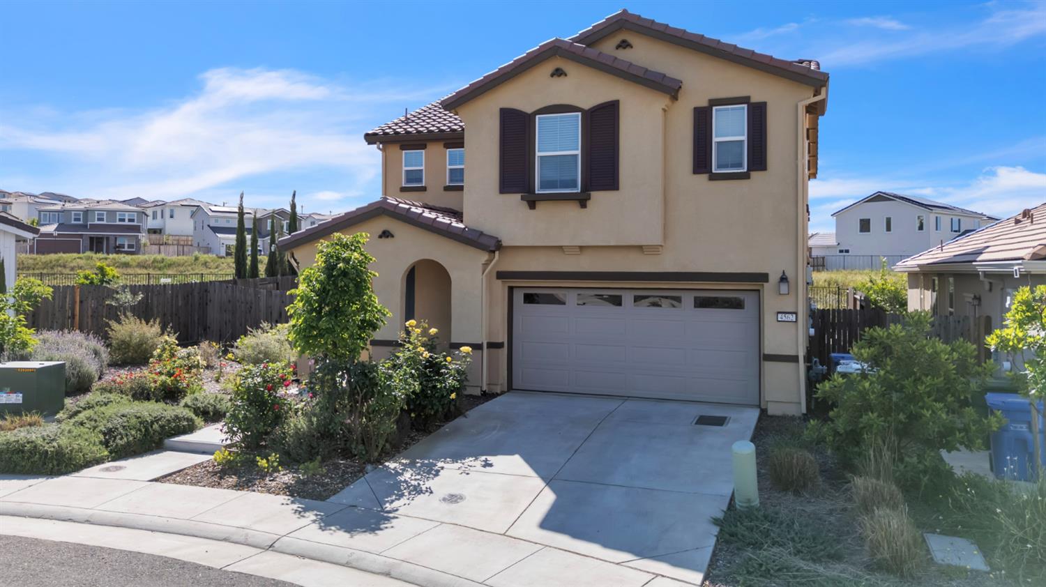 4562 Butterfly Ridge Drive Folsom, CA 95630 - Photo 2 of 44 a front view of a house with a garden