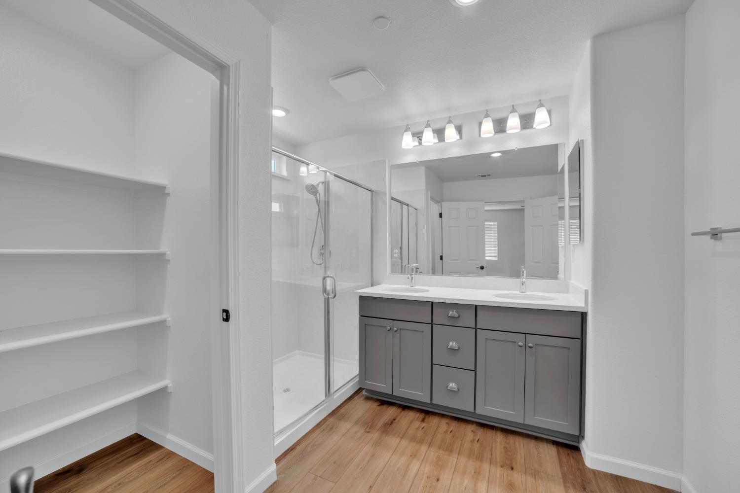 4562 Butterfly Ridge Drive Folsom, CA 95630 - Photo 25 of 44 a bathroom with a double vanity sink and a mirror