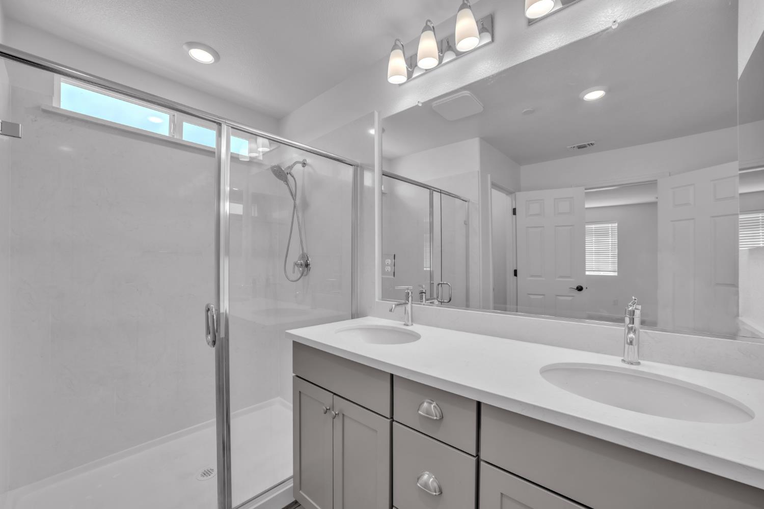 4562 Butterfly Ridge Drive Folsom, CA 95630 - Photo 26 of 44 a bathroom with a double vanity sink mirror and shower