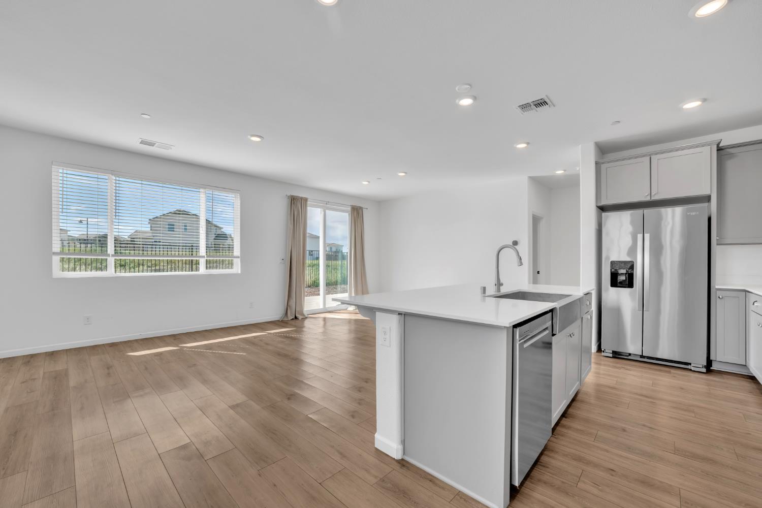 4562 Butterfly Ridge Drive Folsom, CA 95630 - Photo 6 of 44 a kitchen with stainless steel appliances granite countertop a refrigerator a sink a stove and wooden floors