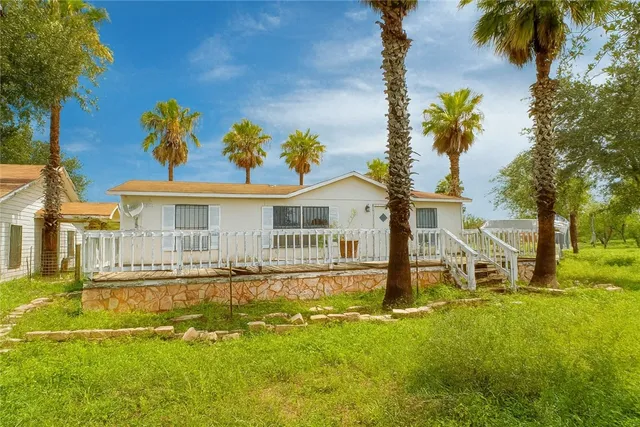 a front view of a house with a yard table and chairs