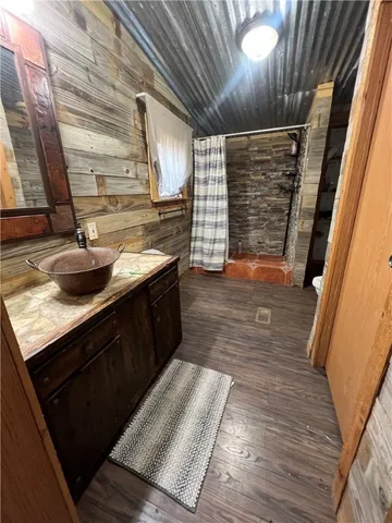 a kitchen with wooden floors and a sink