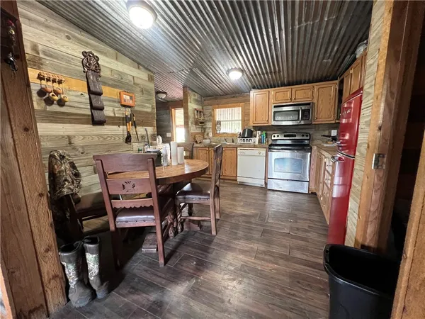 a dining room with furniture and a kitchen view