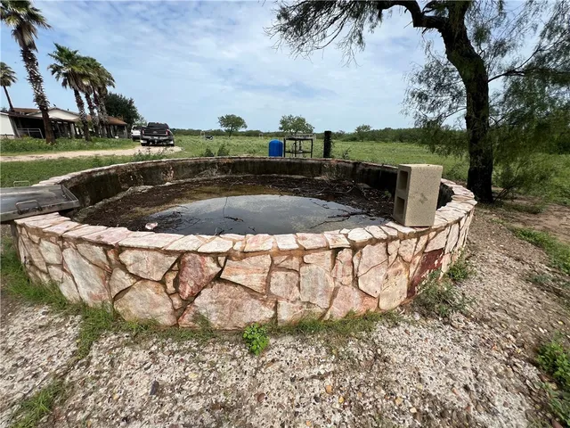 a view of backyard with outdoor seating and green space