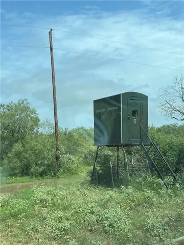 a green field covered with trees in the background